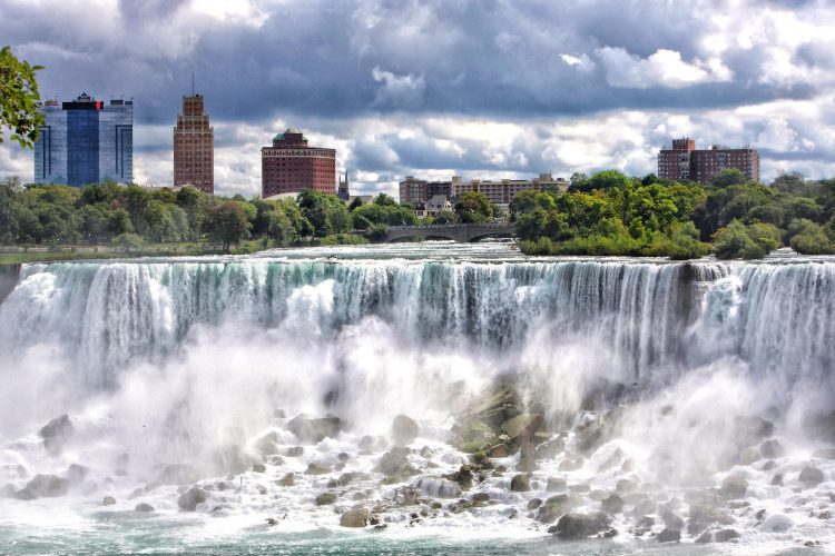 The American side of Niagara Falls with scenic river falls , parks and hotels