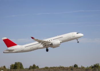 Air Canada plane flies in the sky.